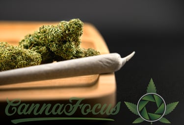 a marijuana leaf sitting on top of a wooden cutting board