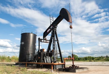 Conventional oil well with pumpjack, surface equipment, and wellhead.