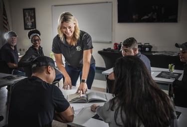 Instructor in a classroom reviewing course materials with the adult students