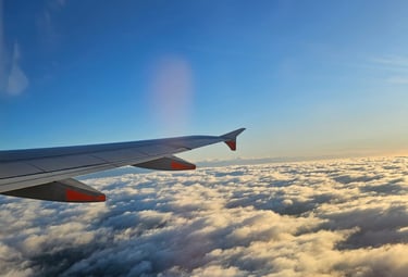 Passenger on a plane overlooking clouds melatonin consultation Aberdeen City Centre