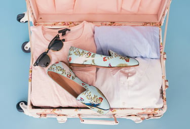 Open suitcase packed for a holiday — period delay service in Aberdeen