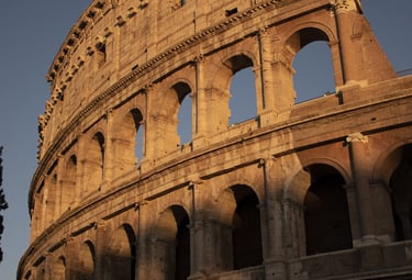 A side view of the majestic Colosseum in Rome at sunset