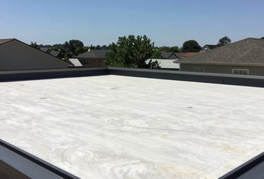Installation of a roof window on a sunny day with green surroundings.