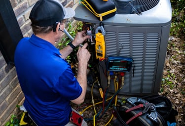 Our technician performing necessary AC maintenance in a home in Arlington Texas