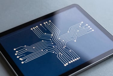 Photography of a high-resolution tablet screen displaying a detailed circuit logic diagram with crisp white lines on a deep blue background, reflecting a soft mist grey ambient light.