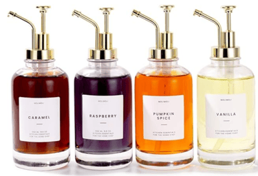 4 coffee syrup bottles with varying syrup flavors