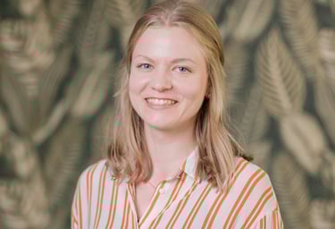 a woman in a striped shirt and jeans