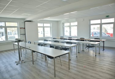 Feltec Paderborn a room with a table and chairs and a whiteboard