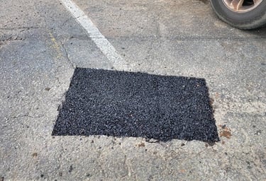 Patched parking lot pothole