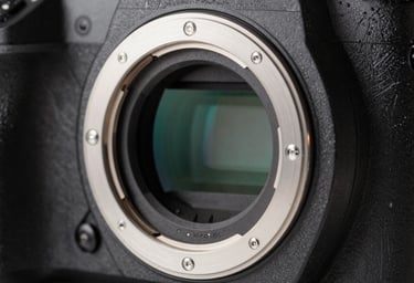 Macro photography of a professional full-frame camera lens mount and internal glass elements, showing intricate mechanical detail and slate gray metallic textures in a North American tech studio.