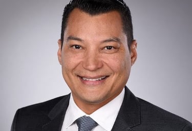 a man in a suit and tie smiling