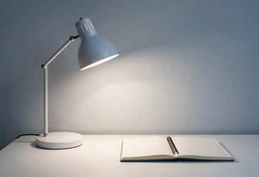 A portrait of a minimalist workspace with a single lamp and a notebook. Sophisticated muted blue and soft white colors, professional and calm mood, Northern European style.