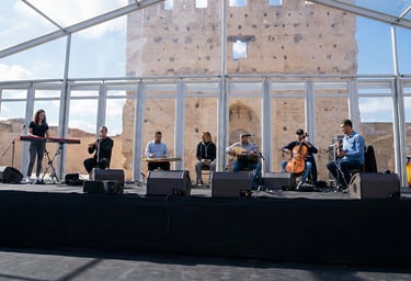 a group of people standing on a stage with instruments