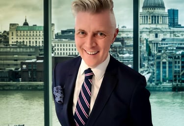 a man in a suit and tie with a boat in the background