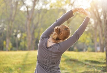 a woman stretching her arms in the air
