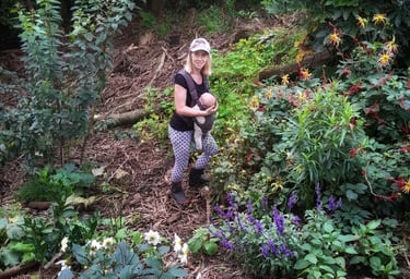 mum in food forest with baby