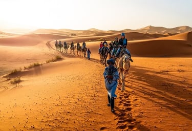 a group of people riding camels in the desert