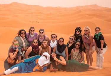 a group of people standing in a desert