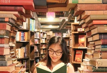 girl reading in a circle of books