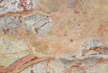 Natural marble stone texture with veins of peach, orange, and gray for architectural design.