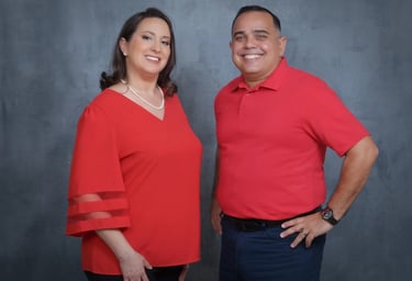 middle aged latin couple wearing red, smiling, rolando and luisa garcia co founders of sunset behavioral health
