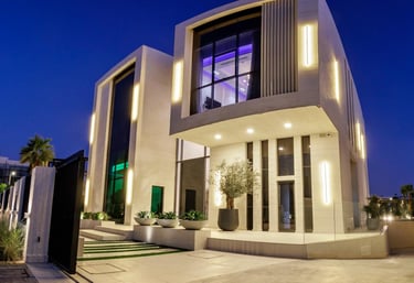 Modern luxury villa at dusk with geometric architecture and glowing lights.