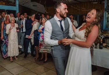 A bride and groom dancing to a high-energy live set from Mosaic wedding band