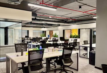 a large open office with a couch and chairs - flexible workspace