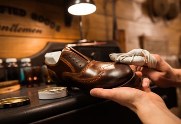 a person is cleaning a shoe with a cloth