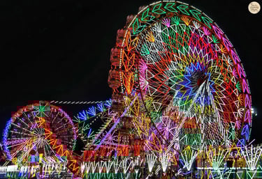 Amusement rides glowing with colorful carnival lights at Kota Dussehra Mela night view.