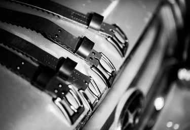 assortment of belts in black and white