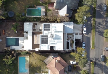 a house with a pool and a pool in the middle of a neighborhood