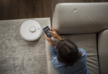 a woman is holding a smart phone and looking at her phone