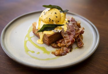 a plate of food with eggs and bacon on it