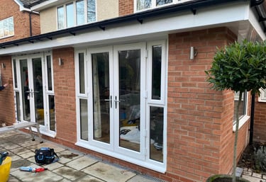 french doors fitted into brickwork and patio