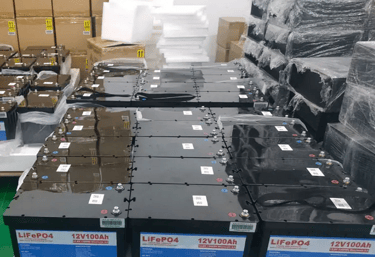 multiple 12 volt 100Ah lithium batteries stacked together in the manufacturing plant