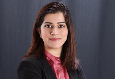 a woman in a black suit and pink shirt