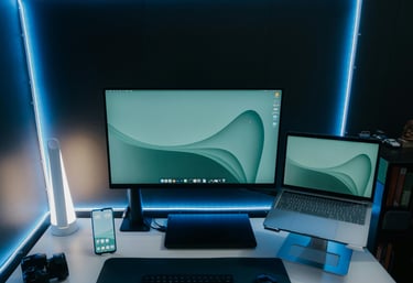 a desk with a laptop and a monitor screen