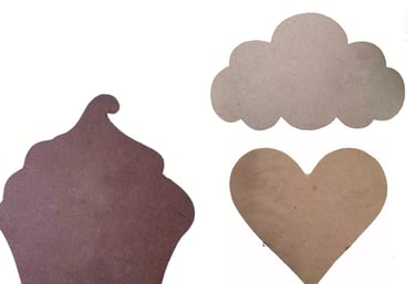 a cupcake cut out of cardboard with a heart shaped cookie