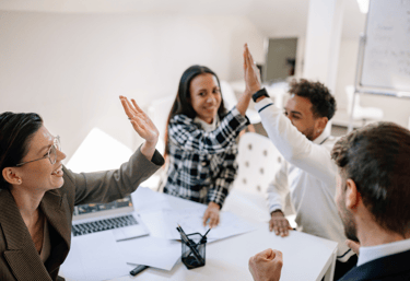 employees high-fiving as it's pay day