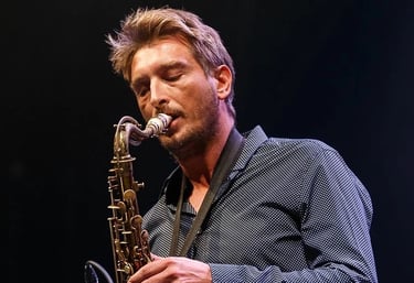 a man playing a saxophone and saxophone