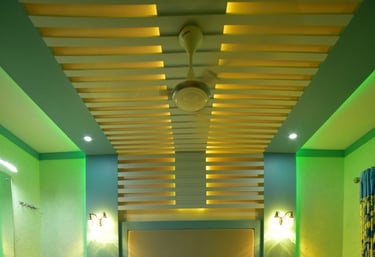 a bed with a white bed and a green wall
