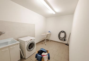 a laundry room with a washing machine and a laundry basket