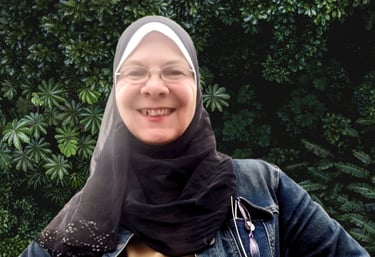 a woman wearing a hijab and smiling