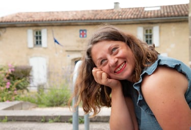 a woman with a blue shirt and a blue jean. Amandine Lebrun massage therapist tantric