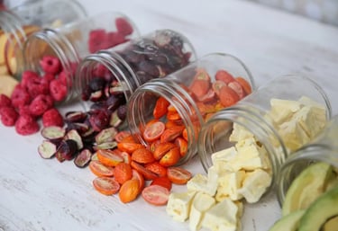 Image of a row of tipped jars, each filled with different freeze-dried goods.
