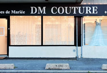 a dressmaker's dress on display in a storefront door
