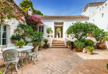 Rustic Spanish villa for rent featuring a charming ivy-covered patio