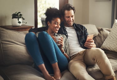 a man and woman sitting on a couch