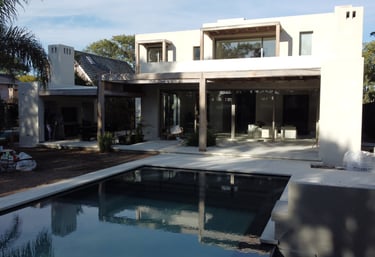 a house with a pool and a pool in the foreground
